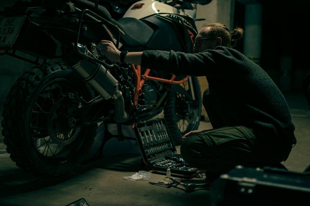 Rider working on a motorcycle in a garage